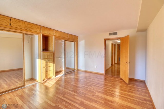 unfurnished bedroom featuring a closet and light hardwood / wood-style floors