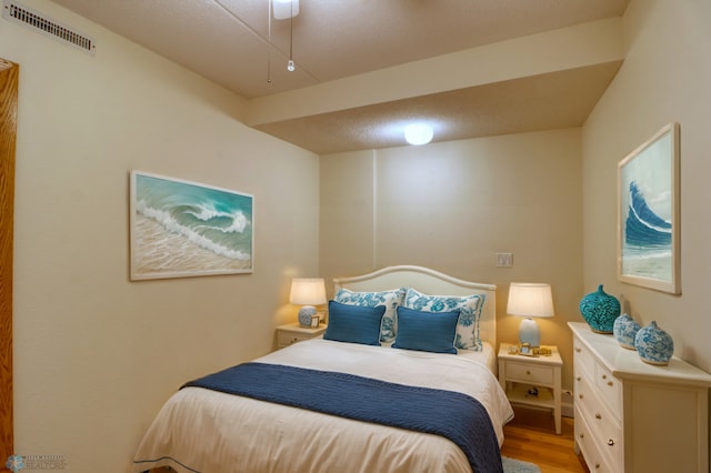 bedroom with light hardwood / wood-style flooring and ceiling fan