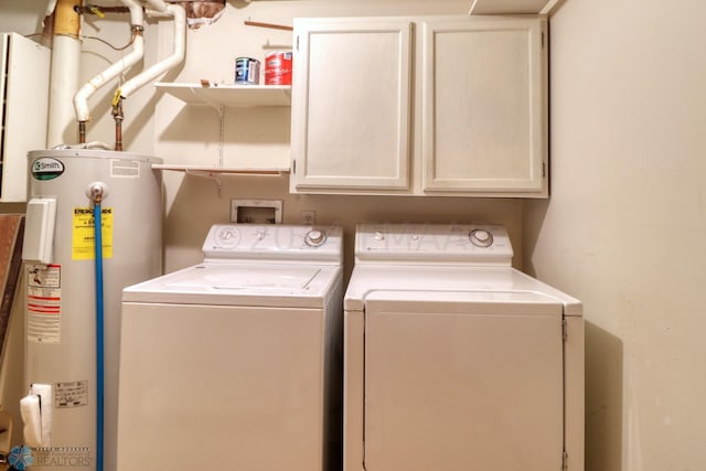 laundry room featuring cabinets, water heater, and washing machine and clothes dryer