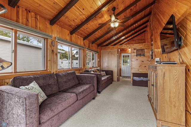 living room with ceiling fan, wood ceiling, wooden walls, lofted ceiling with beams, and light carpet