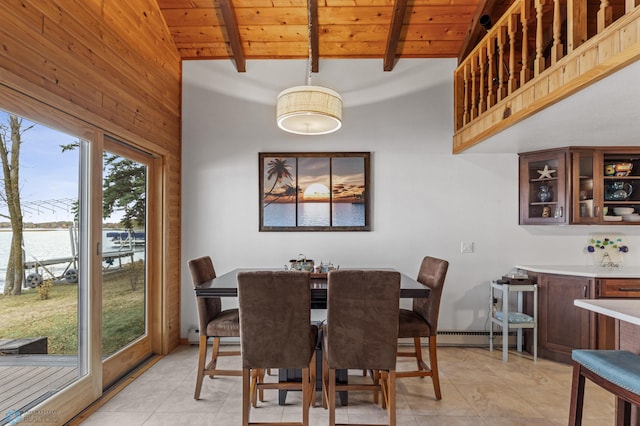 tiled dining room with vaulted ceiling with beams, a water view, and wooden ceiling