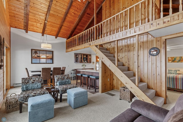 living room featuring wood walls, carpet, beam ceiling, wood ceiling, and high vaulted ceiling