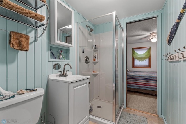 bathroom with an enclosed shower, vanity, and toilet