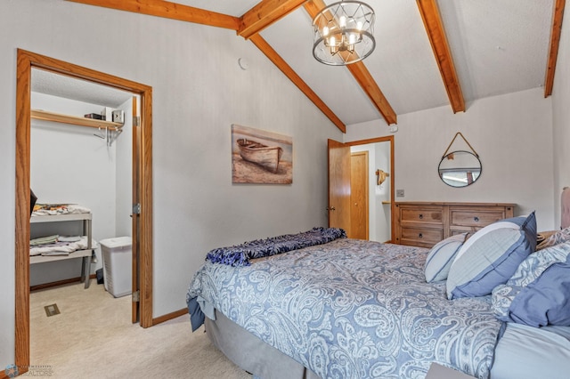 bedroom with a notable chandelier, vaulted ceiling with beams, a closet, and light colored carpet