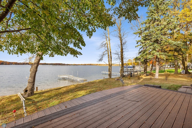 wooden deck featuring a water view and a dock