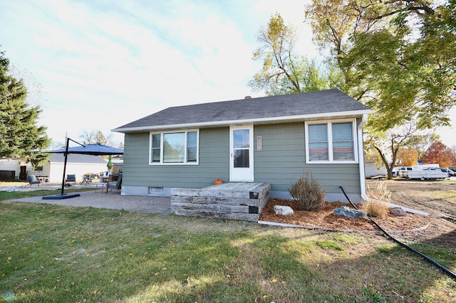 bungalow-style home with a patio area and a front yard