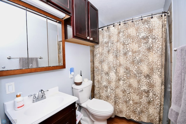 bathroom featuring toilet, a shower with curtain, and vanity