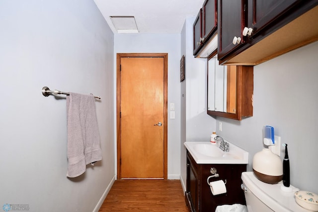 bathroom featuring vanity, toilet, and hardwood / wood-style floors