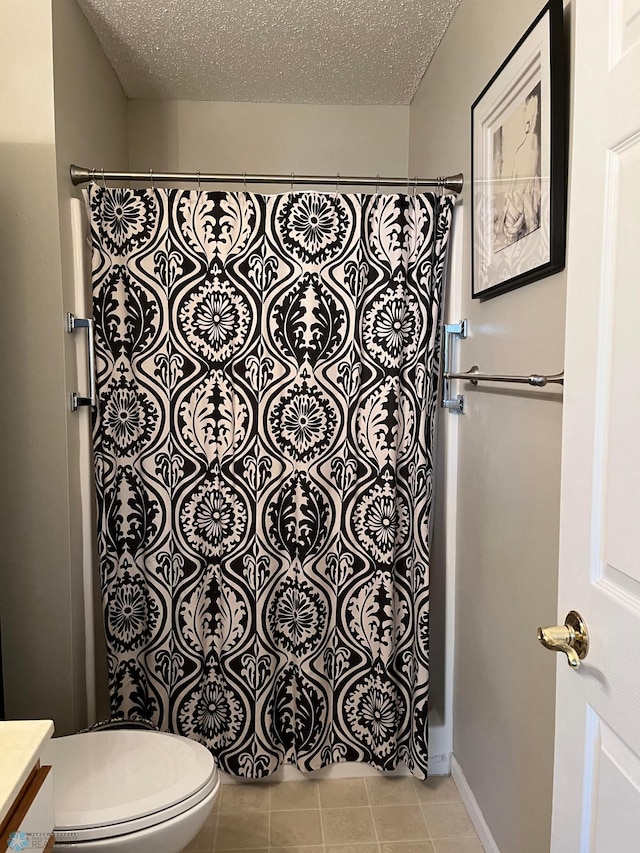 bathroom with toilet, a textured ceiling, walk in shower, and vanity