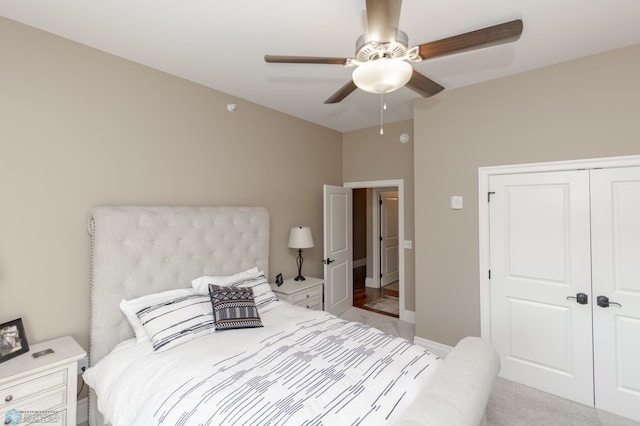 bedroom featuring a closet, ceiling fan, and light carpet