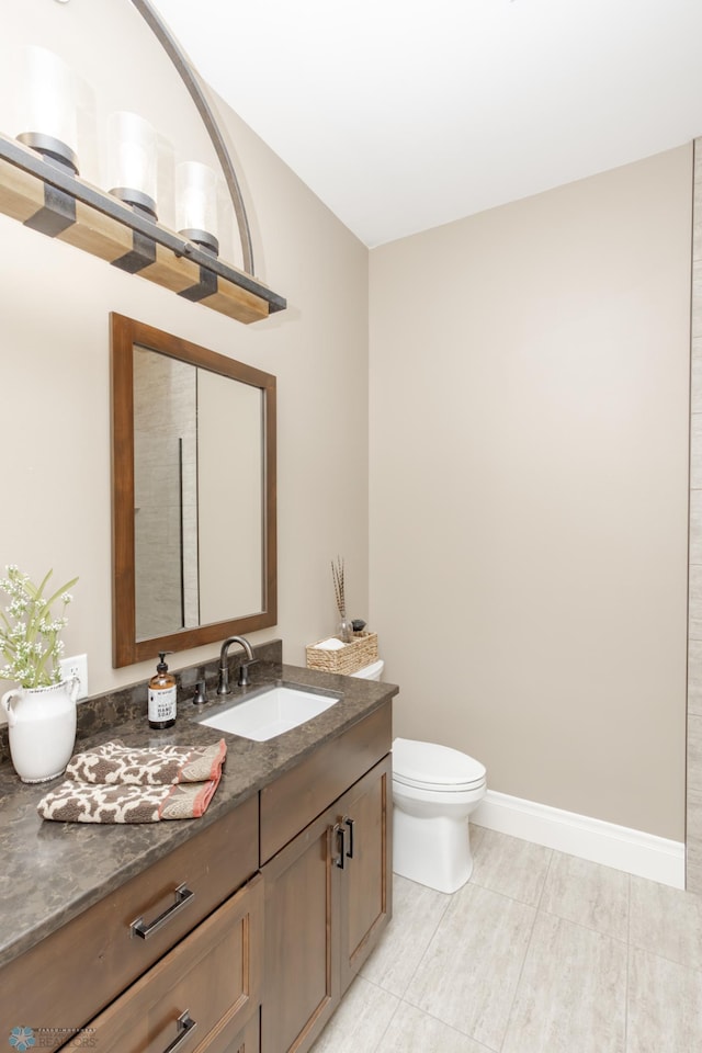 bathroom featuring vanity, toilet, and tile patterned flooring