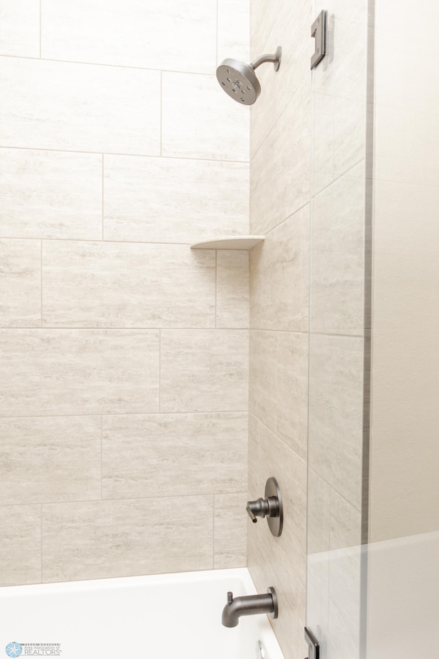 details with tiled shower / bath combo