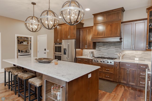 kitchen featuring a center island, appliances with stainless steel finishes, pendant lighting, and dark hardwood / wood-style flooring