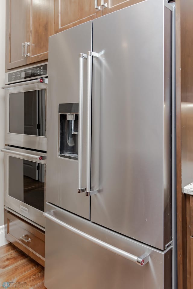 kitchen featuring appliances with stainless steel finishes and light wood-type flooring