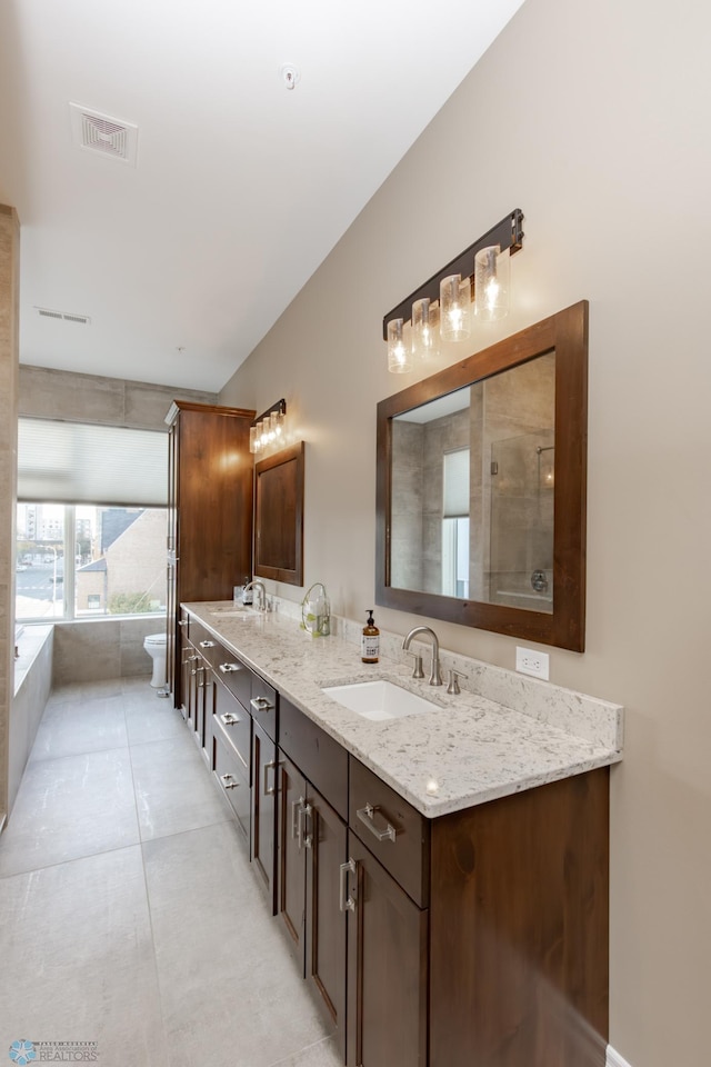 full bathroom with toilet, shower with separate bathtub, vanity, and tile patterned floors