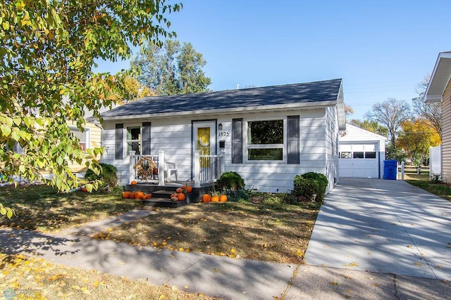 view of front of home featuring a garage and an outbuilding