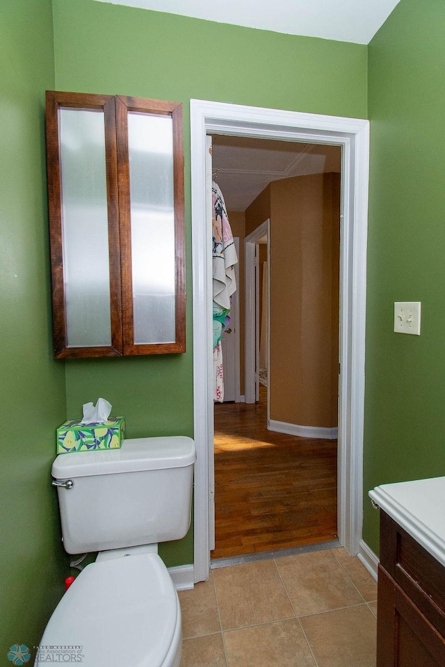 bathroom with vanity, toilet, and wood-type flooring