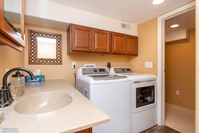 laundry room with independent washer and dryer and sink