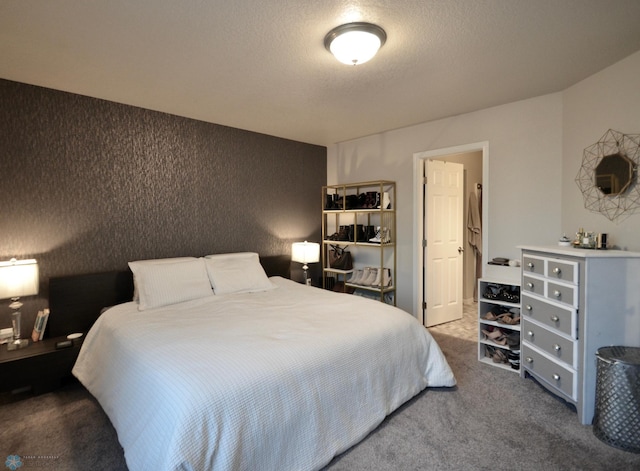 bedroom with carpet floors and a textured ceiling