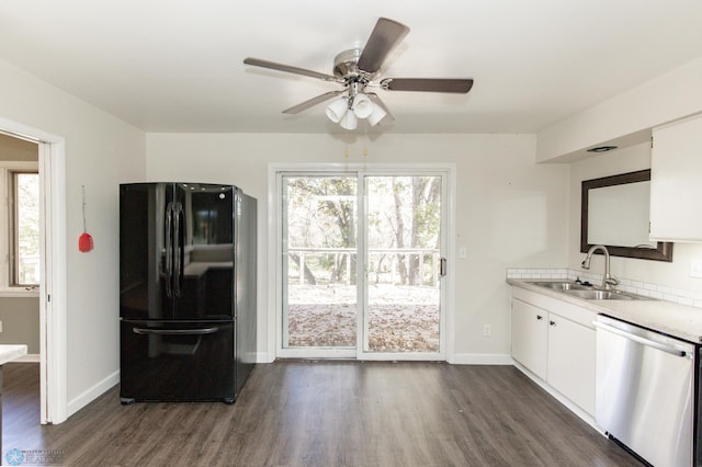 kitchen featuring black refrigerator, sink, stainless steel dishwasher, white cabinets, and dark hardwood / wood-style flooring