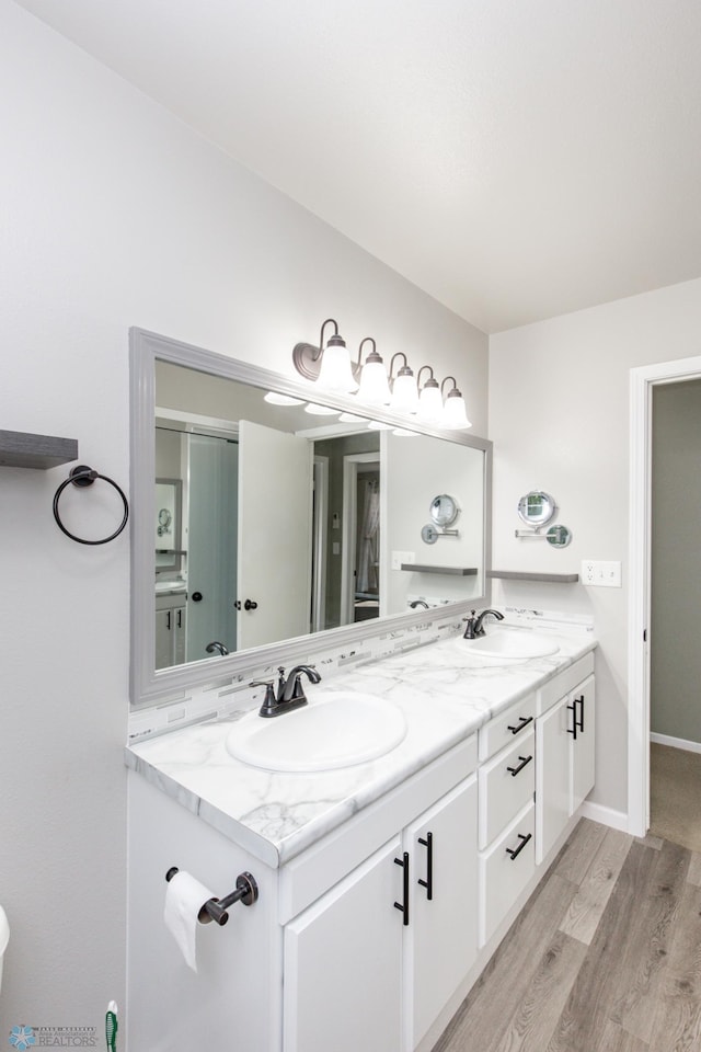 bathroom featuring vanity and hardwood / wood-style floors