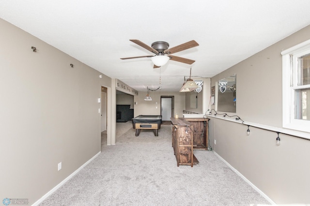 interior space with light colored carpet and ceiling fan