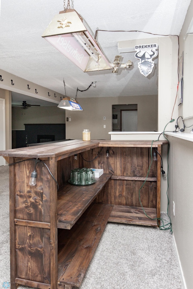 bathroom with ceiling fan and a textured ceiling