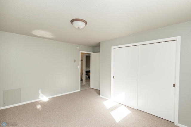 unfurnished bedroom featuring a closet and carpet