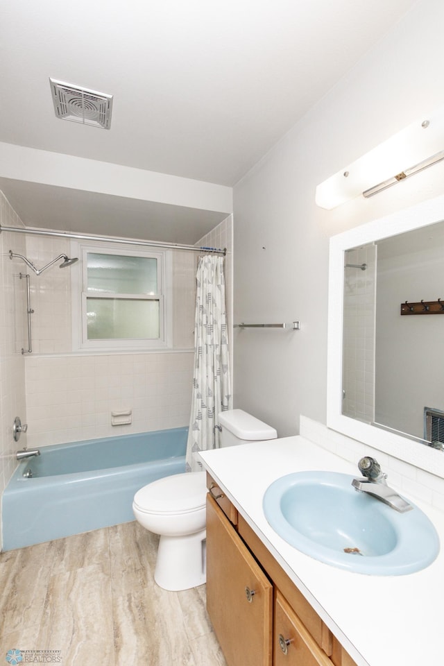 full bathroom featuring vanity, shower / bath combination with curtain, and toilet