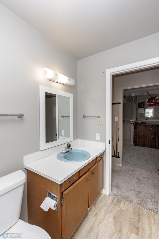 bathroom featuring toilet and vanity