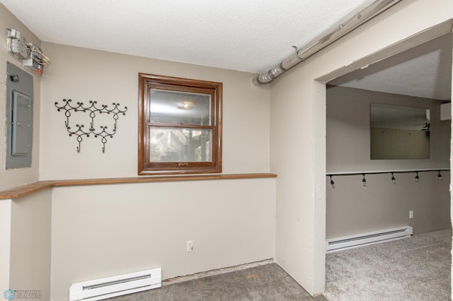 empty room with electric panel, a textured ceiling, carpet, and a baseboard heating unit