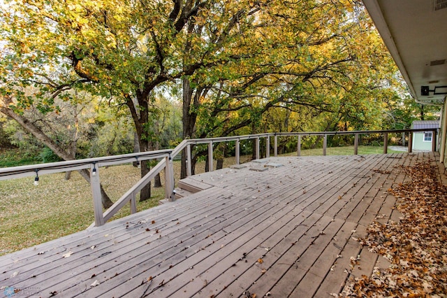 wooden deck with a storage shed