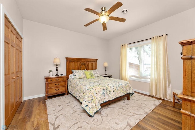 bedroom with wood-type flooring, a closet, and ceiling fan