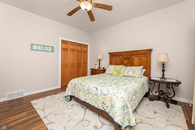 bedroom with a closet, ceiling fan, and dark hardwood / wood-style floors