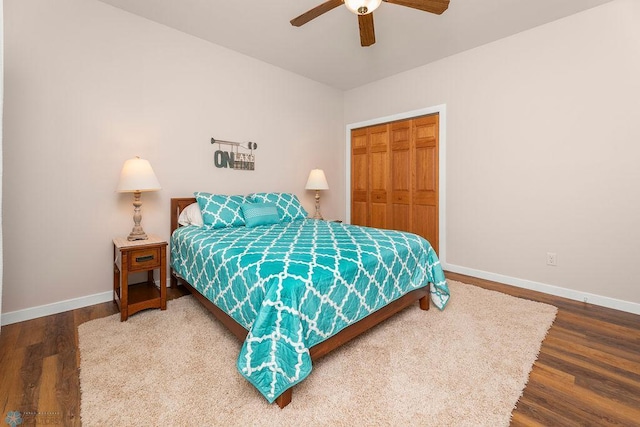 bedroom with wood-type flooring, a closet, and ceiling fan