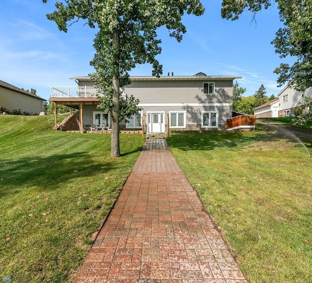 rear view of property with a yard