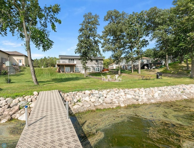 exterior space featuring a yard and a water view