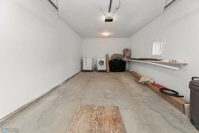 garage with washer / dryer and a garage door opener