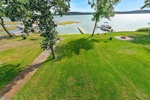 view of yard featuring a water view and a dock