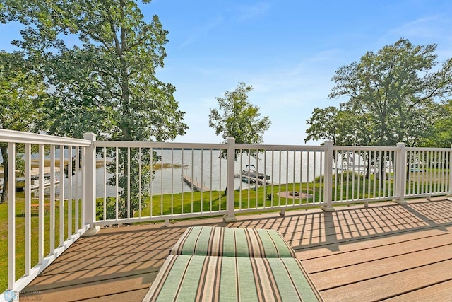 wooden deck with a yard and a water view