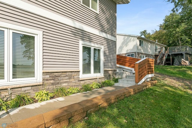 view of home's exterior featuring a yard and a wooden deck