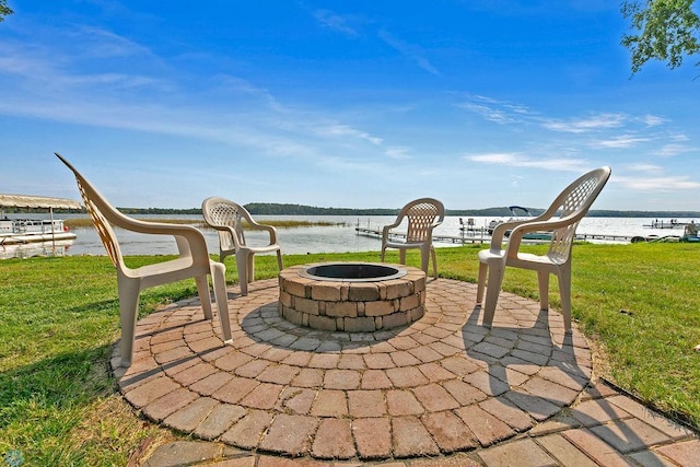 view of patio with an outdoor fire pit and a water view