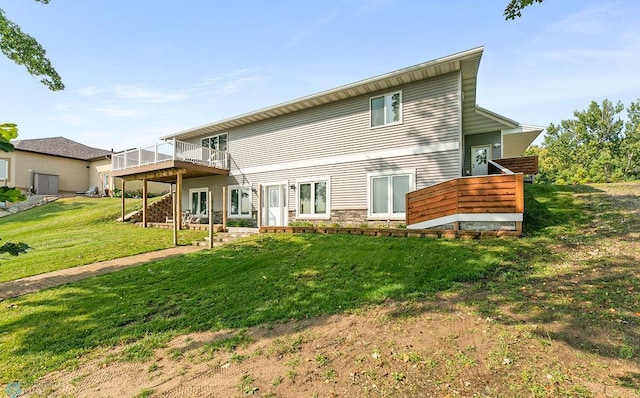 back of property with a yard and a wooden deck