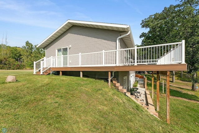 rear view of property with a wooden deck and a yard