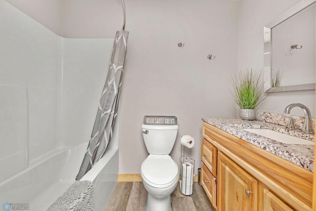 full bathroom with toilet, hardwood / wood-style floors, shower / bath combination with curtain, and vanity