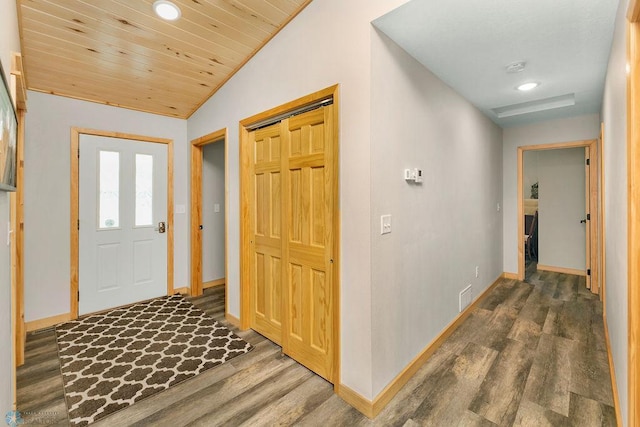 foyer entrance with vaulted ceiling, dark hardwood / wood-style floors, and wooden ceiling