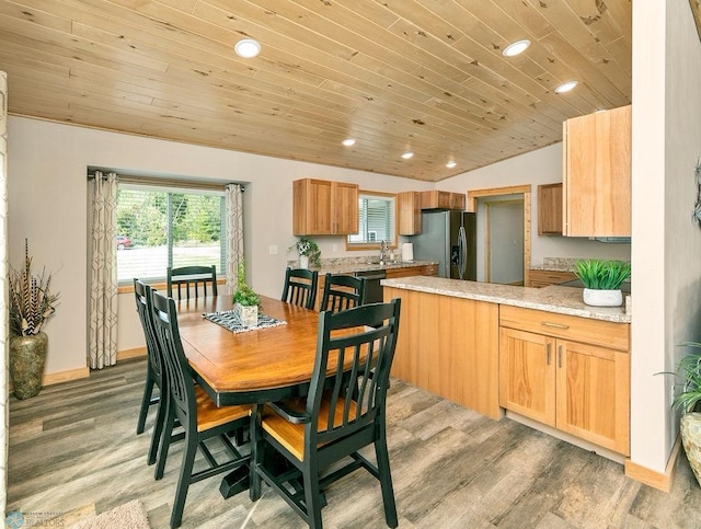 dining space with light hardwood / wood-style floors, wood ceiling, and lofted ceiling