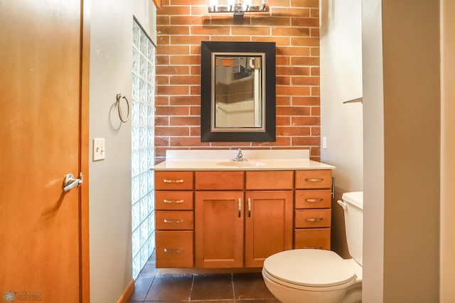 bathroom featuring vanity, toilet, and tile patterned flooring