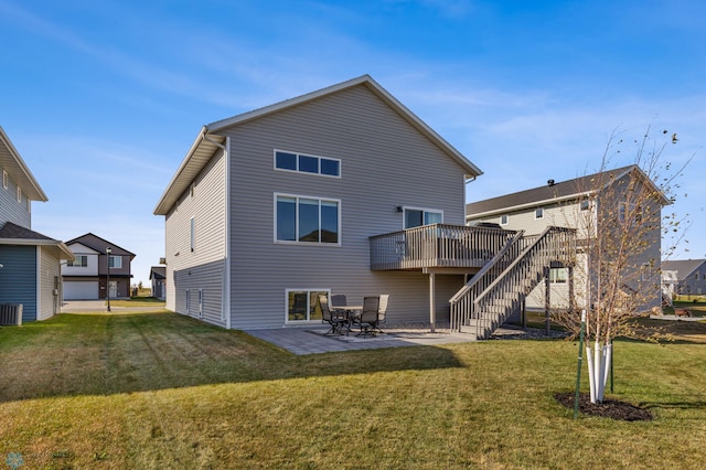 rear view of house with a patio, a deck, and a lawn