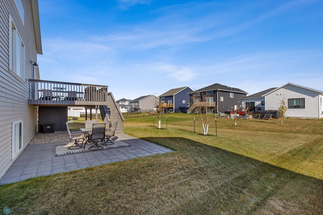 view of yard featuring a patio and a wooden deck